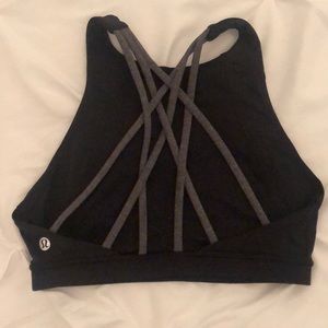 Lululemon black sports bra with grey straps on the back and crew neck top.